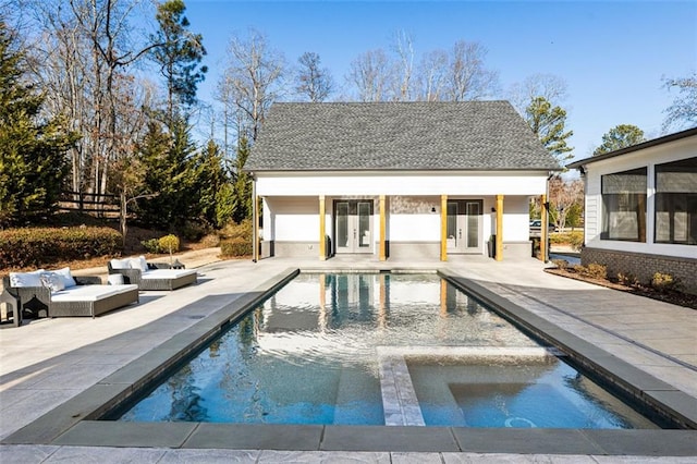 view of swimming pool with an outdoor structure and a patio