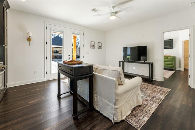 living room featuring dark hardwood / wood-style flooring, french doors, and ceiling fan