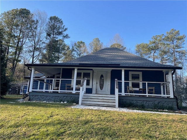 view of front of home with a porch, a shingled roof, and a front lawn