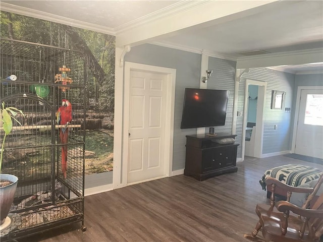 living room with ornamental molding, baseboards, and wood finished floors