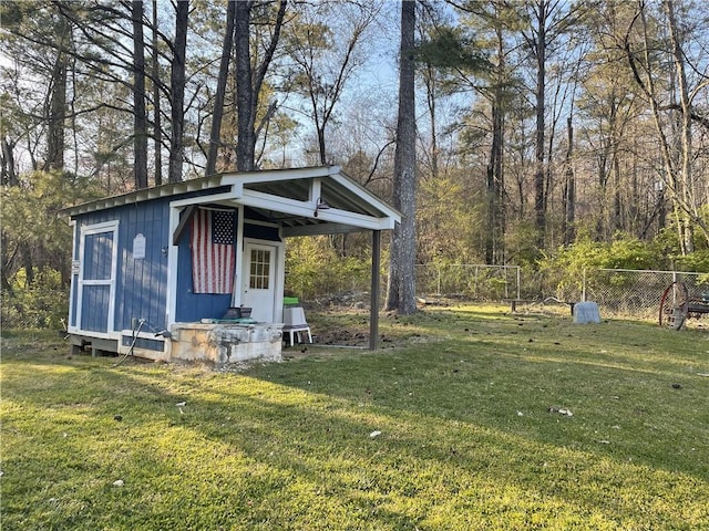 view of yard featuring an outdoor structure and fence