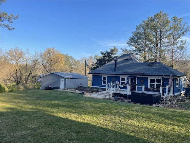 rear view of property with a yard, a wooden deck, and a hot tub