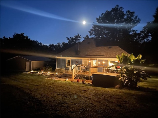 back of house at twilight with a deck