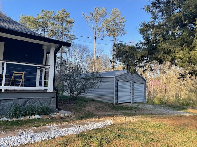 view of side of property with a lawn and an outbuilding