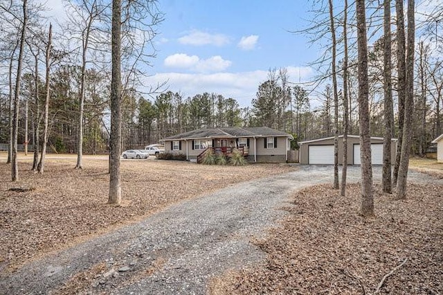 view of front of home with a detached garage and an outdoor structure