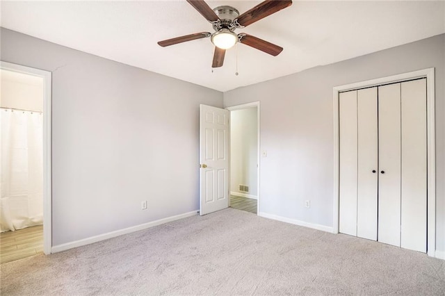 unfurnished bedroom with a closet, carpet, and baseboards