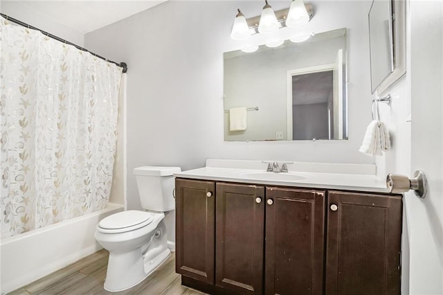 bathroom featuring toilet, shower / bath combination with curtain, wood finished floors, and vanity