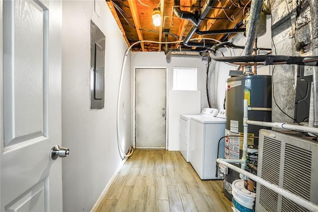 laundry room featuring laundry area, light wood finished floors, electric panel, water heater, and separate washer and dryer