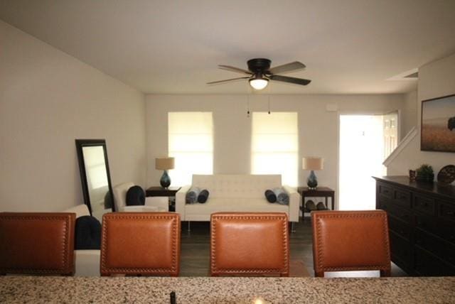 dining area with a ceiling fan and wood finished floors
