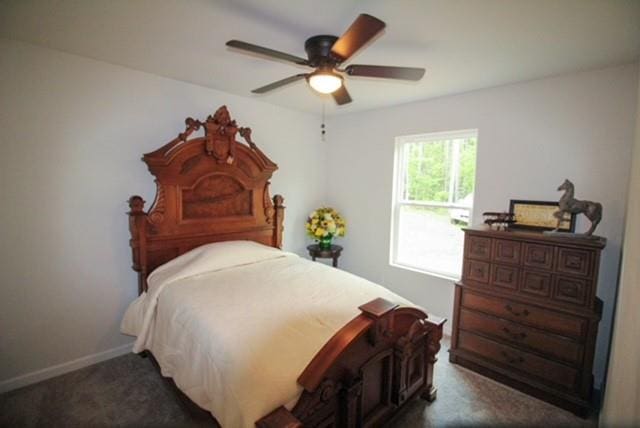 carpeted bedroom featuring baseboards and a ceiling fan