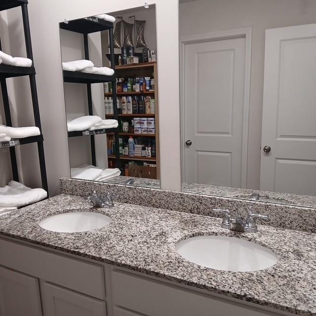 bathroom with double vanity and a sink