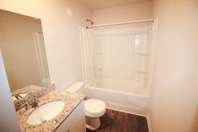 full bathroom featuring vanity, shower / bath combo, toilet, and wood finished floors