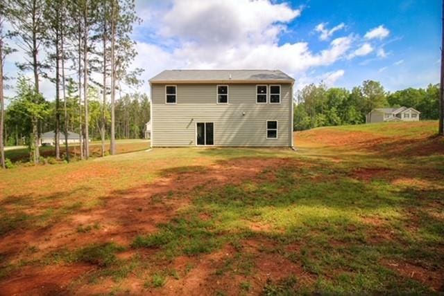 rear view of house with a lawn