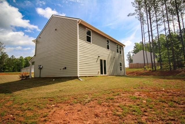 back of house featuring a yard