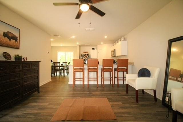 interior space featuring baseboards, recessed lighting, ceiling fan, and wood finished floors