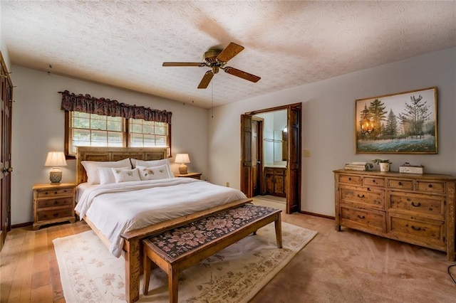 bedroom featuring connected bathroom, a textured ceiling, and ceiling fan