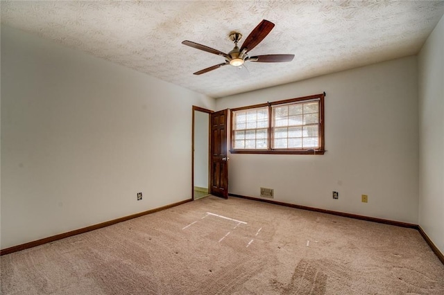 spare room with light carpet, a textured ceiling, and ceiling fan