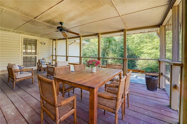 sunroom / solarium featuring a healthy amount of sunlight and ceiling fan