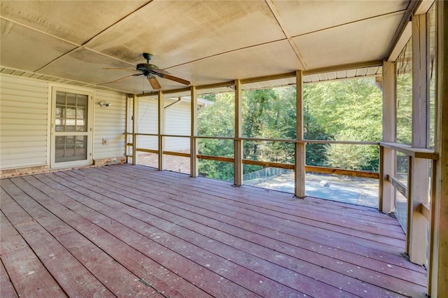 unfurnished sunroom featuring ceiling fan