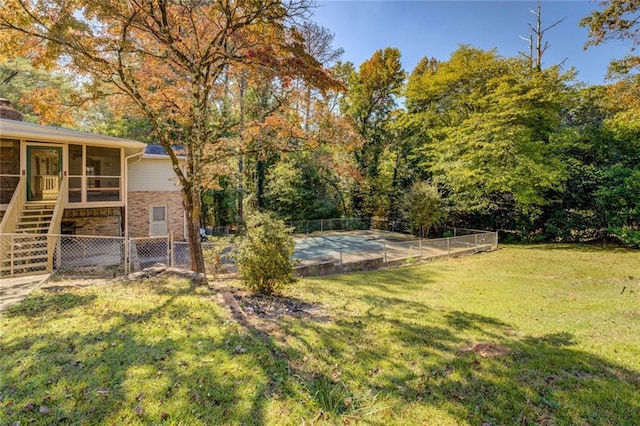 view of yard with a sunroom and a patio area