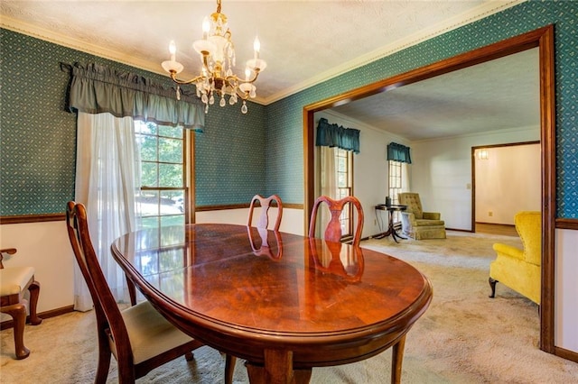 dining room with a notable chandelier, carpet flooring, and crown molding