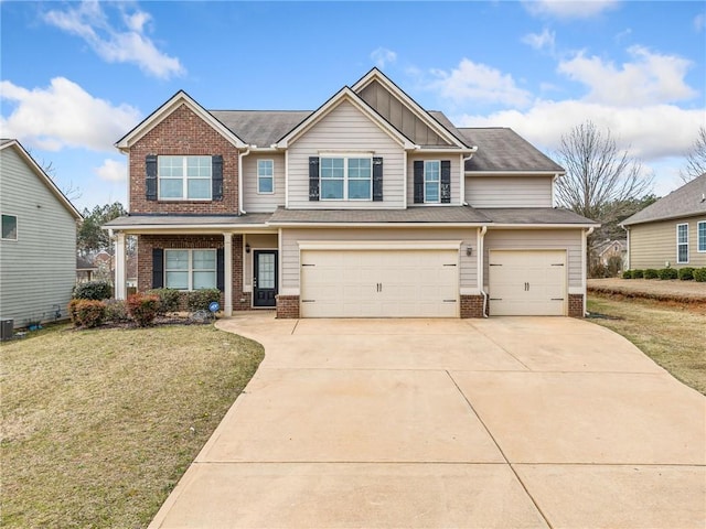 view of front of property with a garage, brick siding, concrete driveway, and a front yard