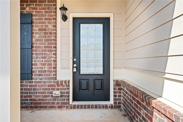 property entrance featuring brick siding