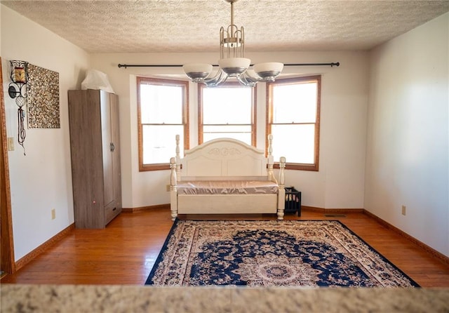 interior space featuring light hardwood / wood-style flooring, a healthy amount of sunlight, and a notable chandelier