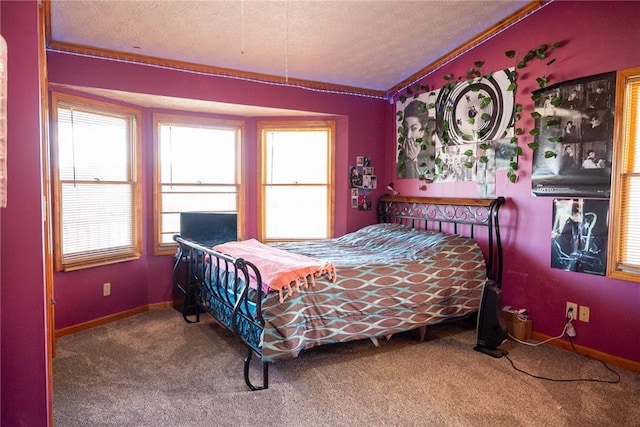 carpeted bedroom featuring a textured ceiling and ornamental molding