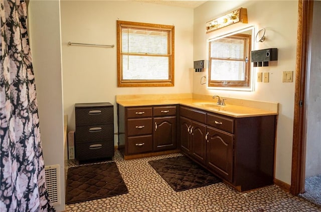 bathroom with vanity, tile patterned floors, and curtained shower