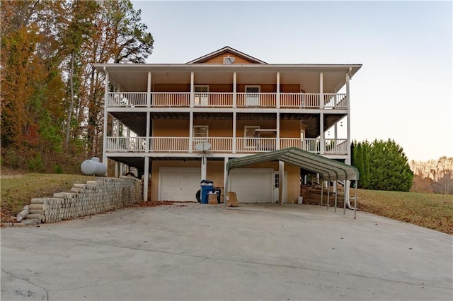 rear view of property with a balcony and a garage