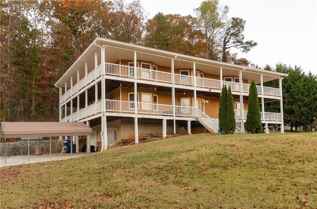 rear view of property featuring a lawn