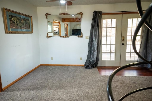 interior space featuring french doors, carpet floors, and ceiling fan