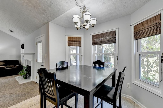 carpeted dining area featuring a notable chandelier, a textured ceiling, and lofted ceiling