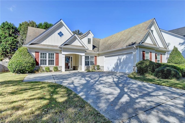 view of front of home with a front yard and a garage