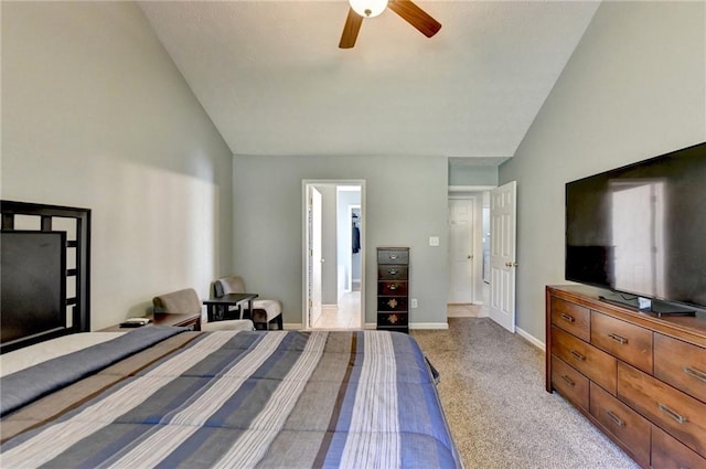 bedroom with light carpet, vaulted ceiling, a walk in closet, and ceiling fan