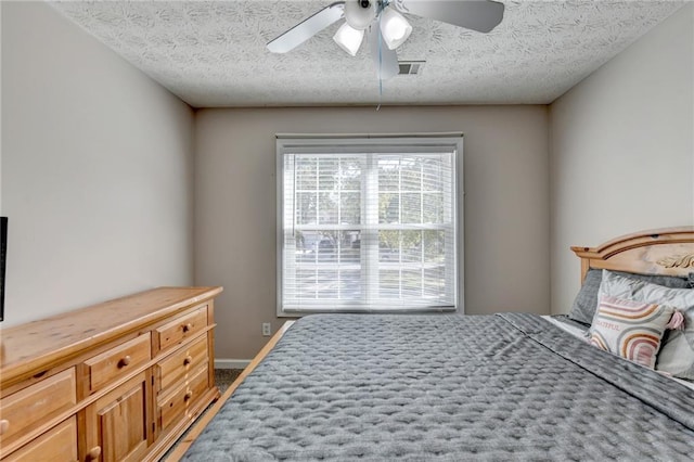 bedroom featuring ceiling fan, a textured ceiling, and hardwood / wood-style floors