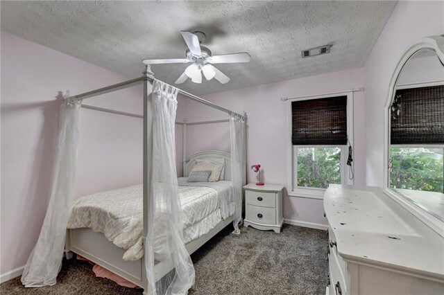 carpeted bedroom with a textured ceiling and ceiling fan