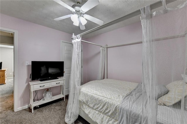 carpeted bedroom with a textured ceiling and ceiling fan