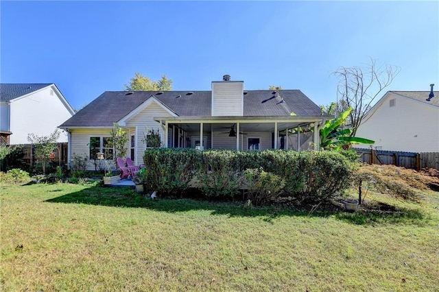 back of property with a lawn and ceiling fan