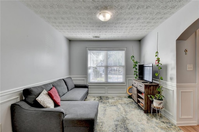 living room featuring hardwood / wood-style flooring and a textured ceiling