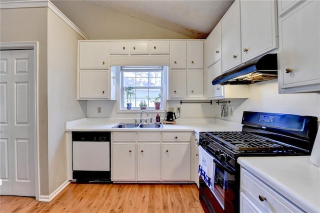 kitchen with lofted ceiling, under cabinet range hood, a sink, dishwasher, and black gas range oven