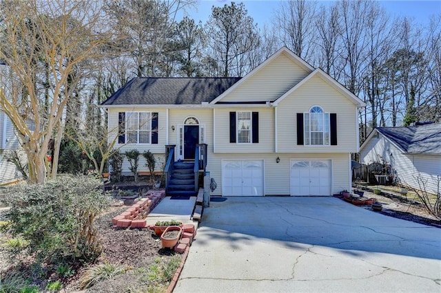 split foyer home with a garage and driveway