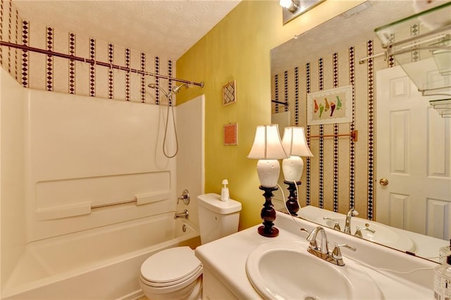 full bath with tub / shower combination, a textured ceiling, toilet, and vanity