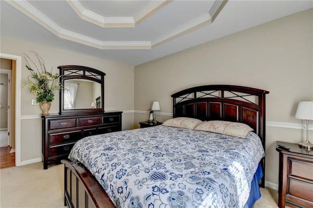 bedroom with baseboards, a tray ceiling, crown molding, and light colored carpet