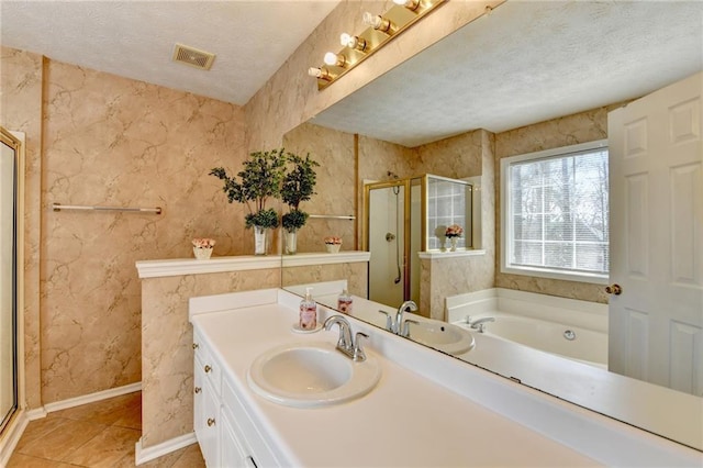 bathroom with a stall shower, visible vents, a textured ceiling, and vanity