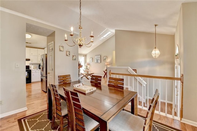 dining room featuring light wood-type flooring, an inviting chandelier, baseboards, and lofted ceiling