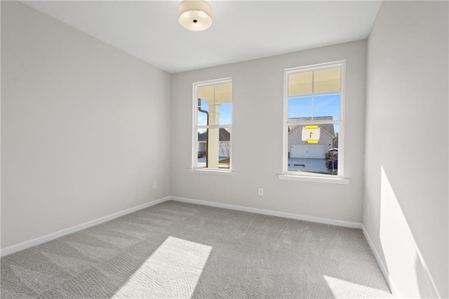carpeted empty room with baseboards