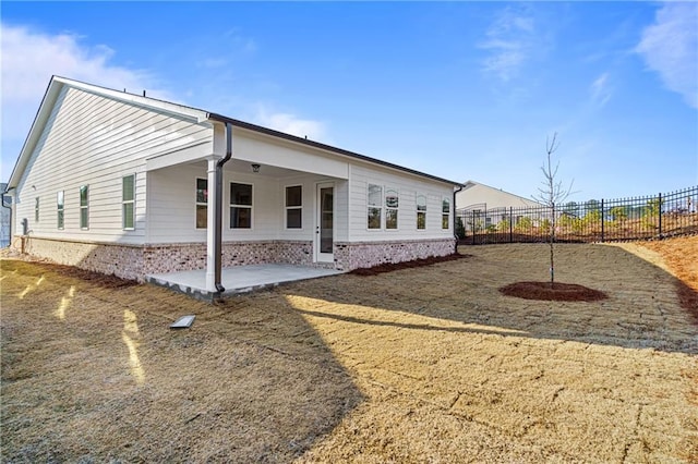 view of side of property featuring a patio area and fence