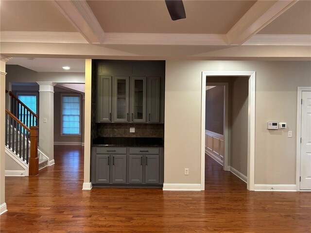 kitchen featuring beamed ceiling, dark hardwood / wood-style flooring, decorative backsplash, and gray cabinetry